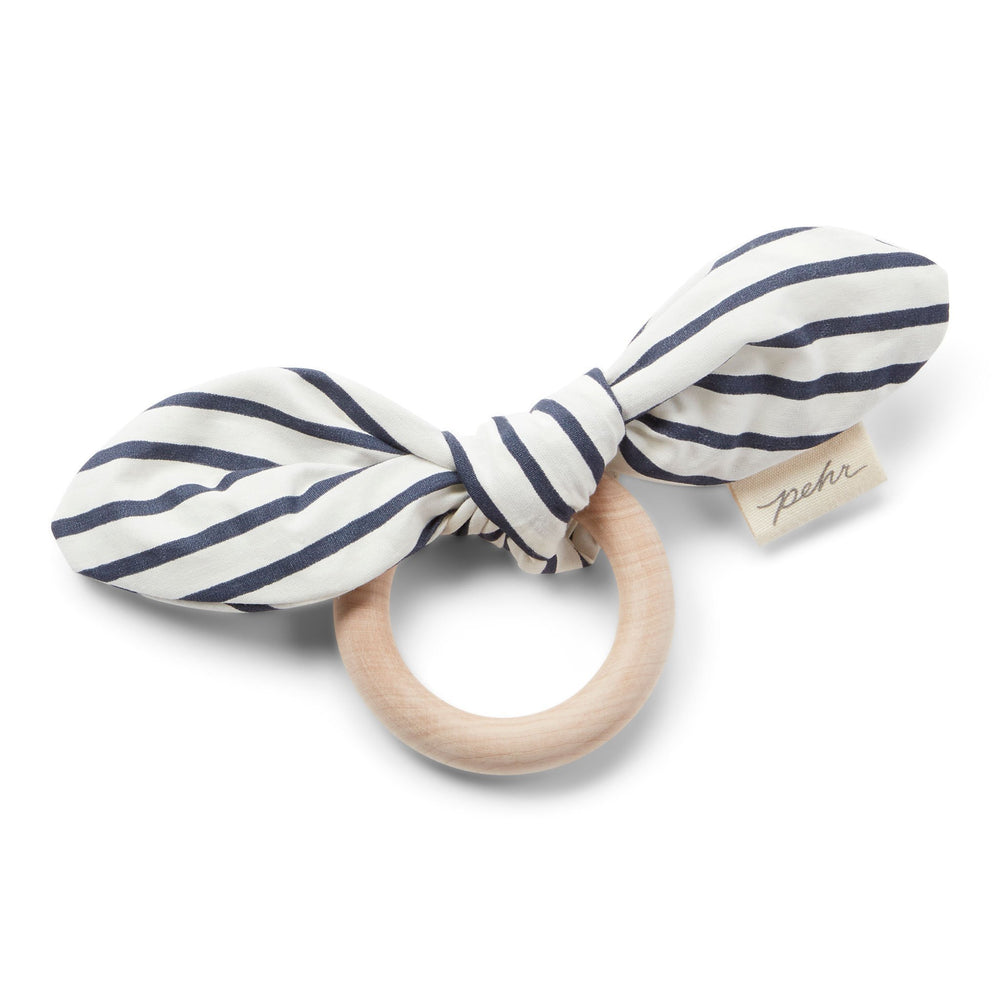Pehr Ink Blue Organic On the Go Teether. GOTS Certified Organic Cotton & Dyes. White bow with dark blue stripes, maple wood ring.