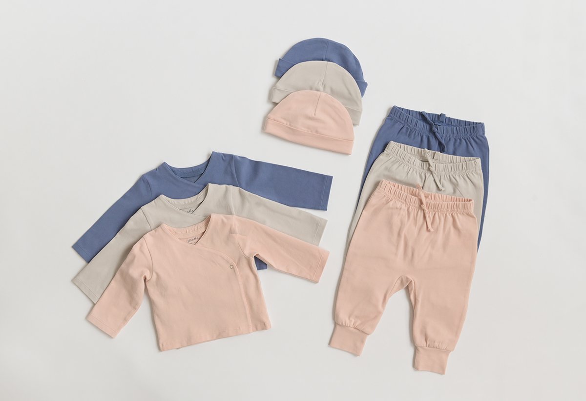 Pehr Essentials Pant, Essentials Wrap Cardigan and Essentials Hat in all three colours layered on top of each other. GOTS Certified Organic Cotton & Dyes.