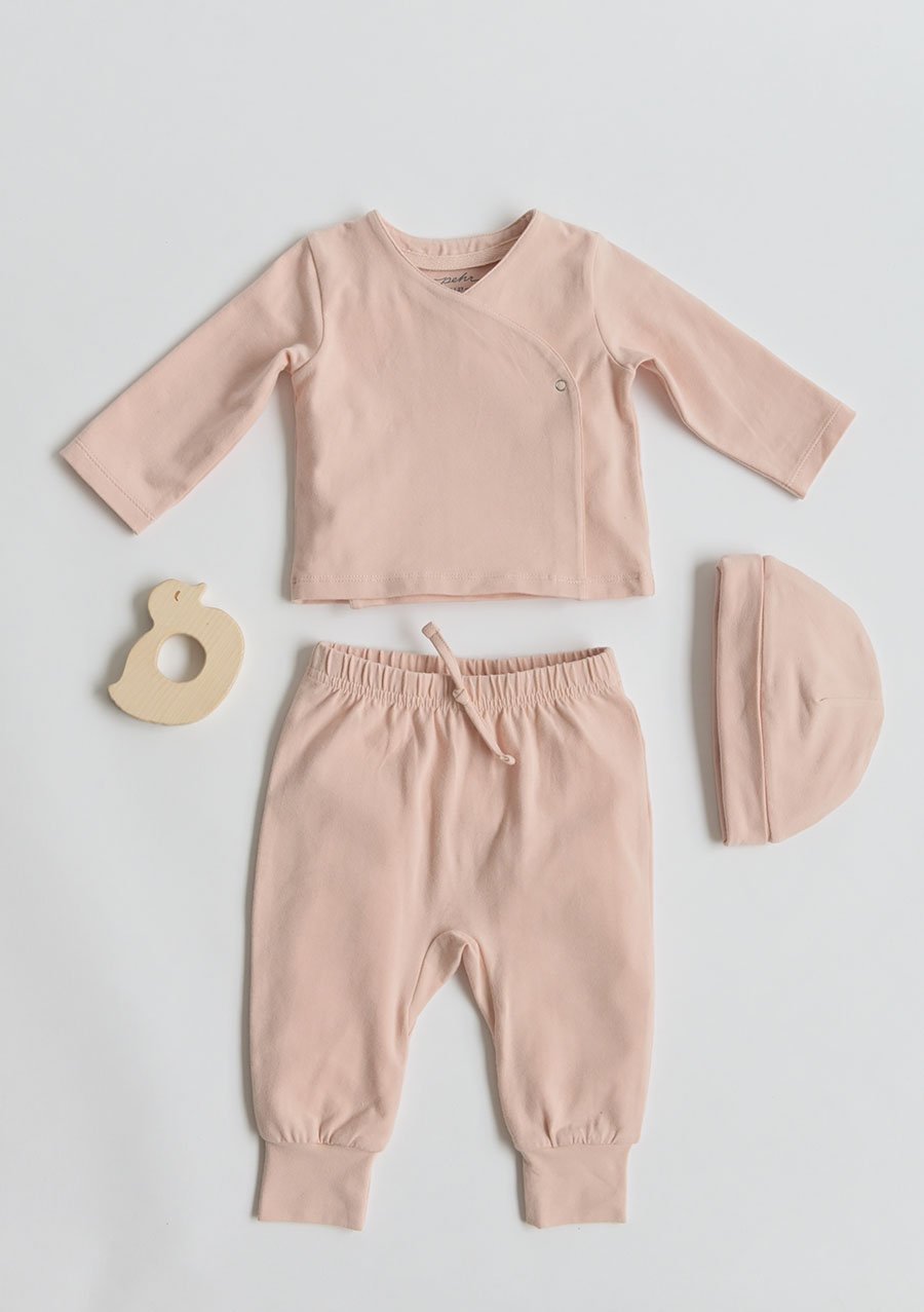 Pehr Powder Pink Essentials Wrap Cardigan with Pehr Powder Pink Essentials Hat and Essentials Pant. GOTS Certified Organic Cotton & Dyes. Light pink wrap cardigan.