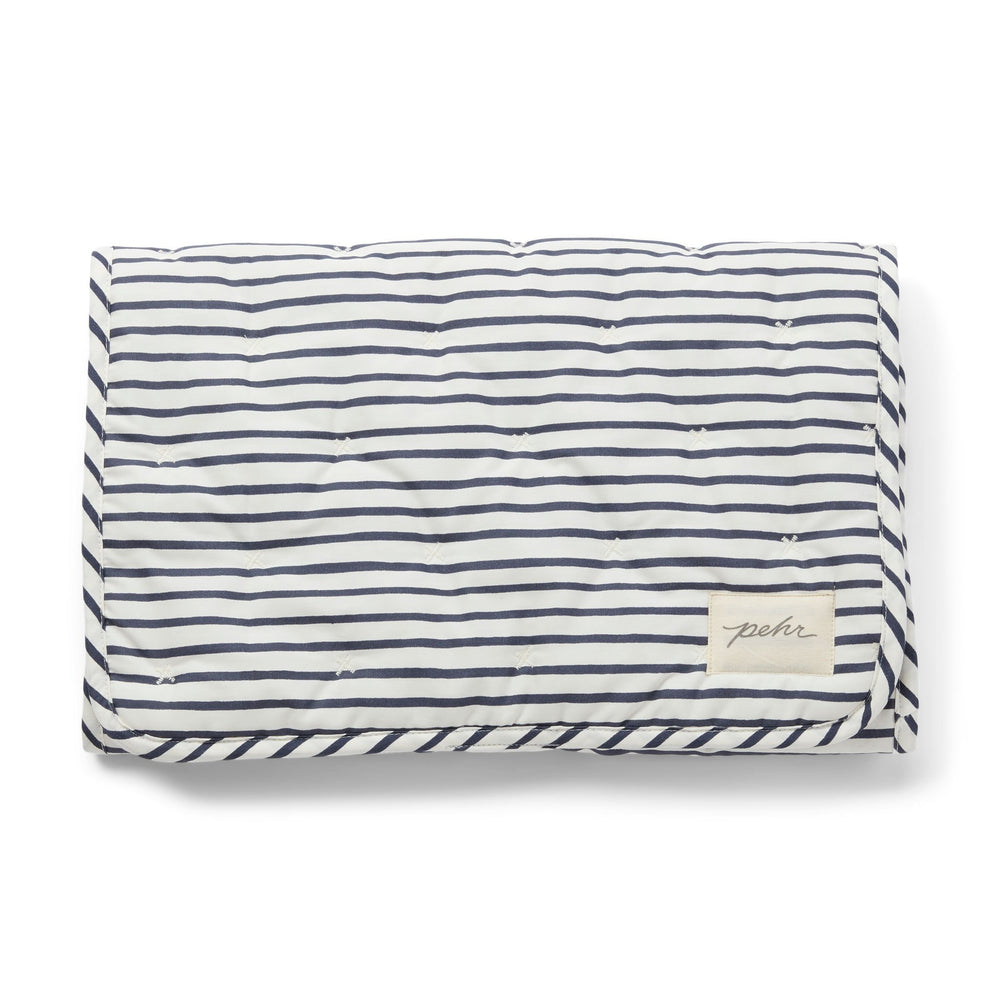 Pehr Ink Blue Organic On The Go Travel Change Pad folded. GOTS Certified Organic Cotton & Dyes. White with dark blue stripes.