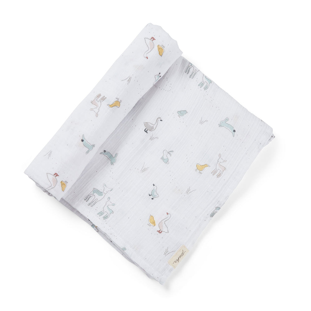Pehr Just Hatched Organic Novelty Swaddles. Organic cotton, hand printed. White with baby animals pattern.