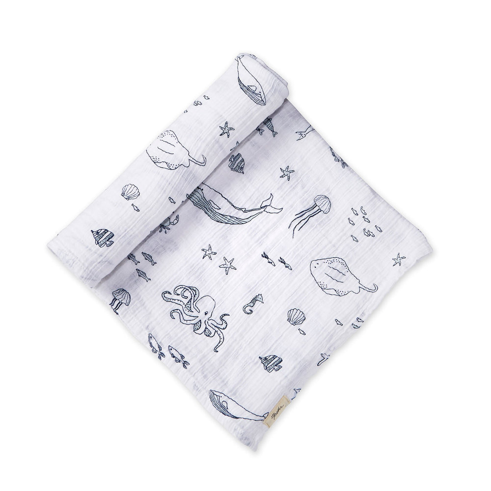 Pehr Marine Life Aquatic Organic Novelty Swaddles. Organic cotton, hand printed. White with blue sea creatures pattern.