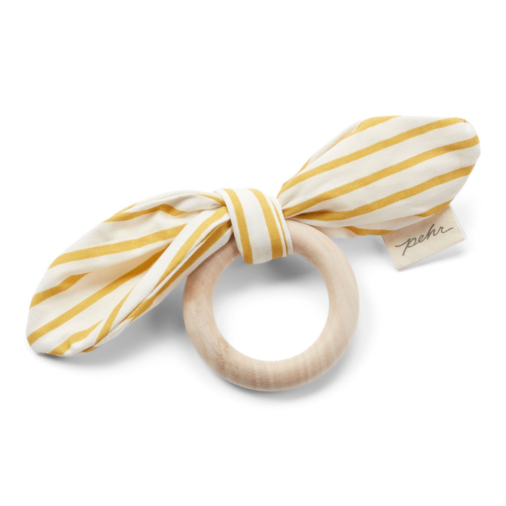 Pehr Marigold Organic On the Go Teether. GOTS Certified Organic Cotton & Dyes. White bow with gold stripes, maple wood ring.