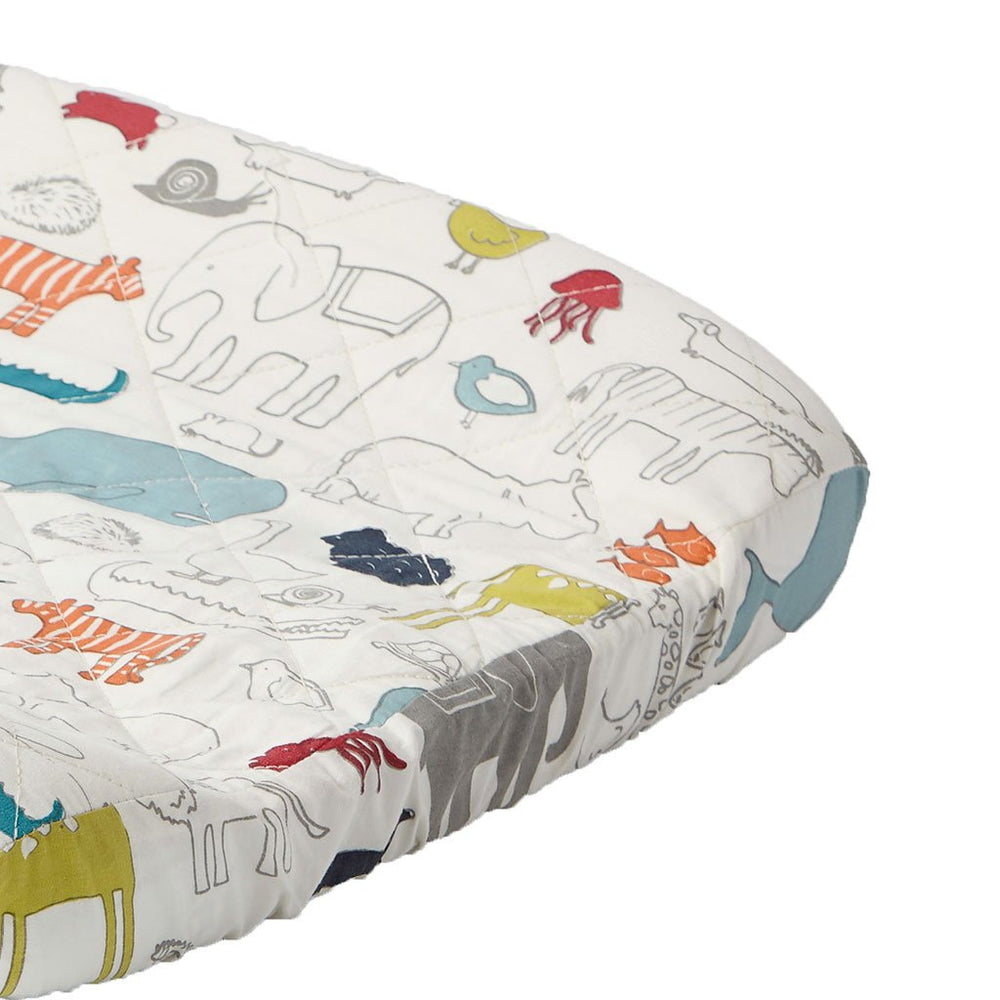 Close up of Pehr Noah's Ark Change Pad Cover. Hand printed. White with coloured animals.