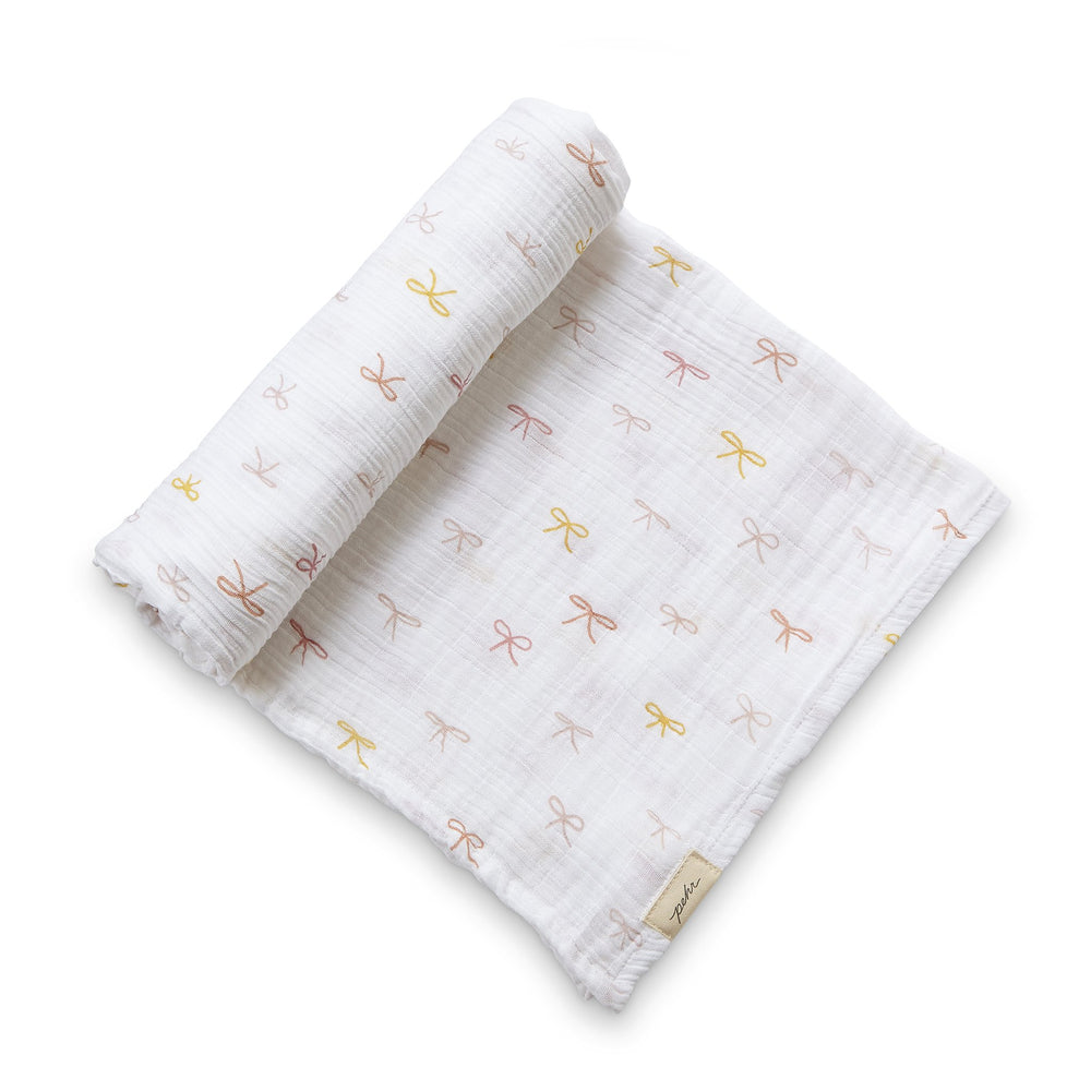 Pehr Jolie Organic Novelty Swaddles. Organic cotton, hand printed. White with little bows pattern.