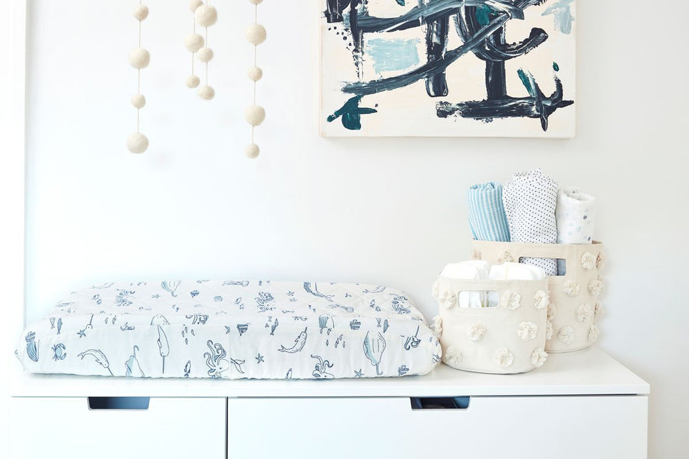 Pehr Life Aquatic Change Pad Cover in nursery. Hand printed. White with navy blue sea creatures in line drawing print.