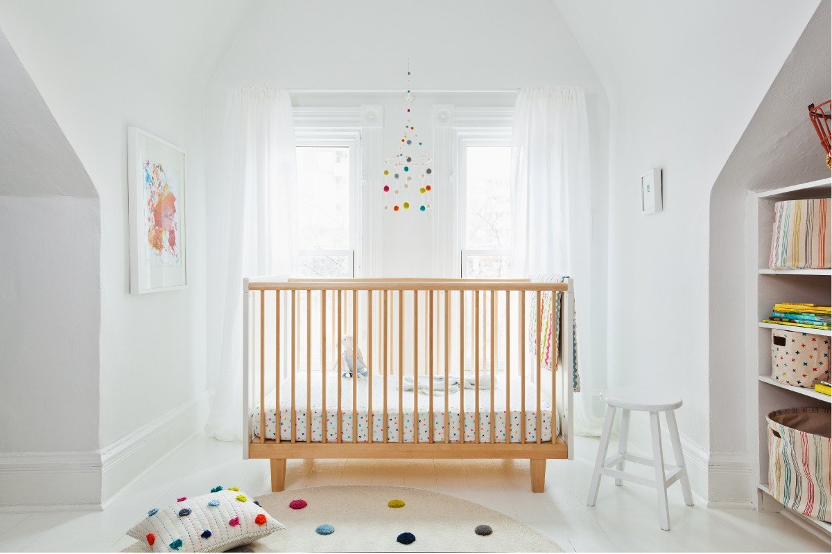 Pehr Merry Go Round Classic Mobile over crib in nursery. Ethically Handmade using 100% wool and AZO-Free dyes. Mobile with colourful dots.