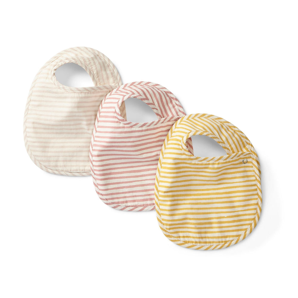 Pehr Stripes Away Pebble Bib Set of 3. Hand printed. White with light pink stripes, white with dark pink stripes, white with gold stripes.
