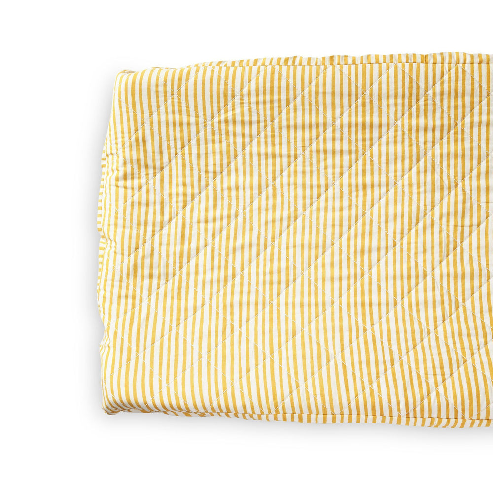 Close up of Pehr Stripes Away Marigold Change Pad Cover. Hand printed. White with gold stripes.