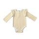 Pehr Stripes Away Marigold with Ruffle Organic One-Piece, Long Sleeve. GOTS Certified Organic Cotton & Dyes. White with gold stripes, long sleeve, ruffles on shoulders, button closure at bottom.