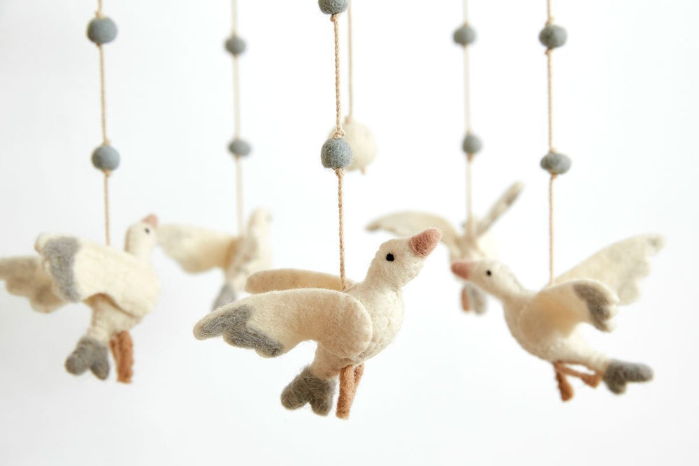 Close up of Pehr Stork Surprise Classic Mobile. Ethically Handmade using 100% wool and AZO-Free dyes. Mobile with Storks.