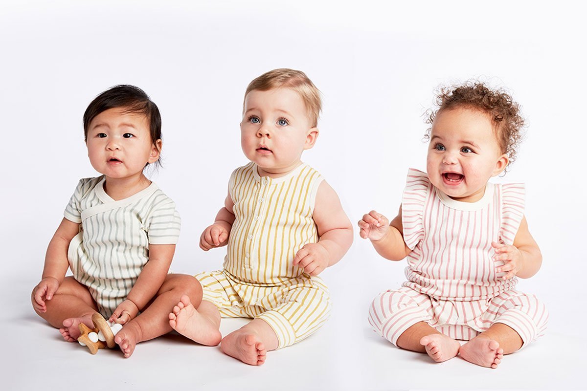 Three babies wearing Pehr Stripes Away Sea Organic Kimono One-Piece, Short Sleeve. GOTS Certified Organic Cotton & Dyes. White with light blue stripes.