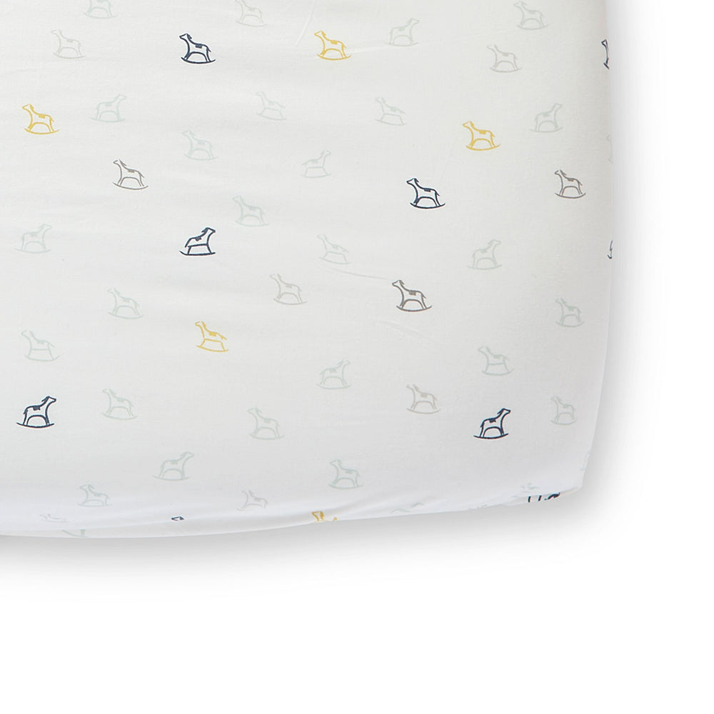 Pehr Rock-A-Bye Organic Crib Sheet. GOTS Certified Organic Cotton. Screen printed by hand using AZO-Free dyes. White with rocking horses.
