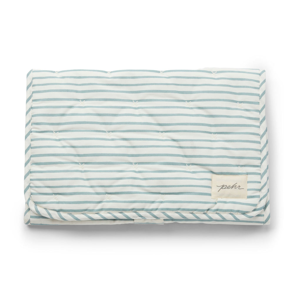 Pehr Deep Sea Organic On The Go Travel Change Pad folded. GOTS Certified Organic Cotton & Dyes. White with blue stripes.