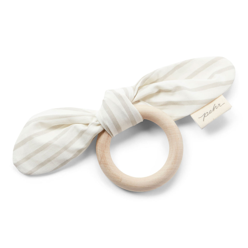Pehr Pebble Organic On the Go Teether. GOTS Certified Organic Cotton & Dyes. White bow with light grey stripes, maple wood ring.